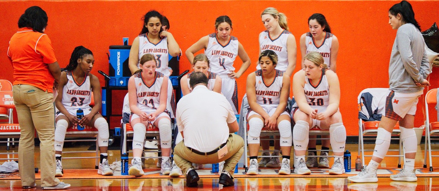 Coach Alan Wilson instructs the Mineola Lady Jackets during a time out in Friday’s home game against Chapel Hill. [more shots, plus prints]